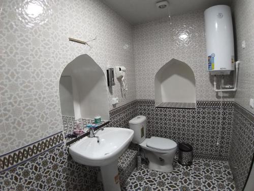a bathroom with a sink and a toilet at Carousel in Khiva