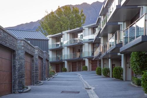 an empty street in front of apartment buildings at Panorama Terrace Apartments - Element Escapes in Queenstown
