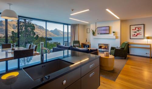 a living room with a view of the mountains at Panorama Terrace Apartments - Element Escapes in Queenstown