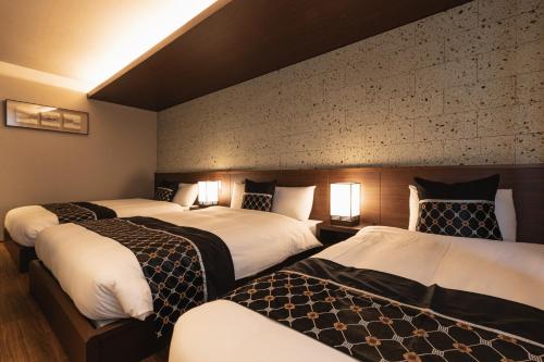 Llit o llits en una habitació de GRAND BASE Iolani