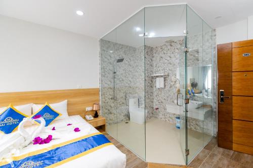 a bedroom with a glass shower and a bed at Mai Hotel - Airport in Ho Chi Minh City