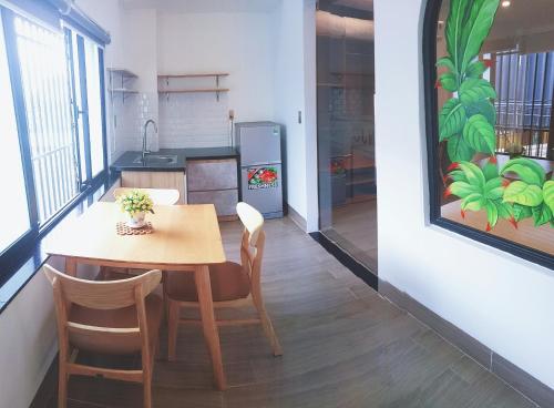 a kitchen and dining room with a table and chairs at ENJOY HOME in Da Nang
