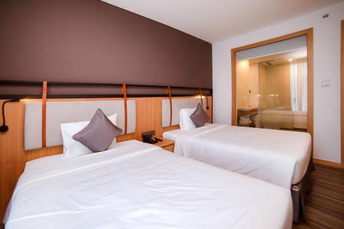 Ένα ή περισσότερα κρεβάτια σε δωμάτιο στο Dragon Style Hotel