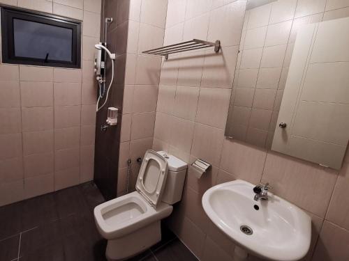 a bathroom with a toilet and a sink at Suite Dream@Icon Residence in Kuala Terengganu