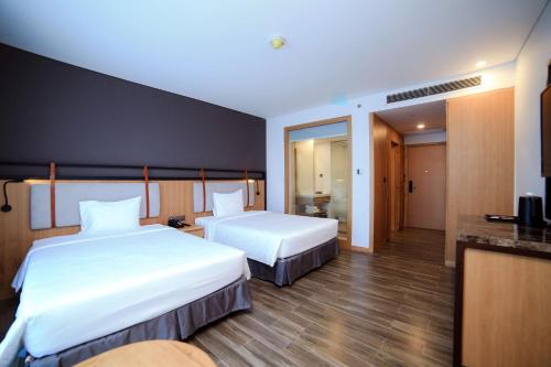 Ένα ή περισσότερα κρεβάτια σε δωμάτιο στο Dragon Style Hotel