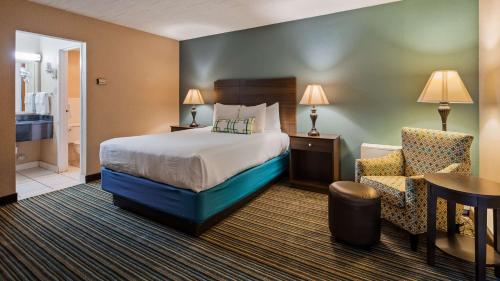 A bed or beds in a room at Best Western Woodhaven Inn