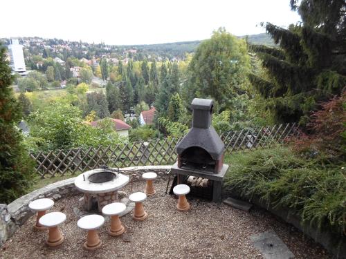a outdoor grill with a bunch of candles around it at Panoráma Szállás in Miskolctapolca