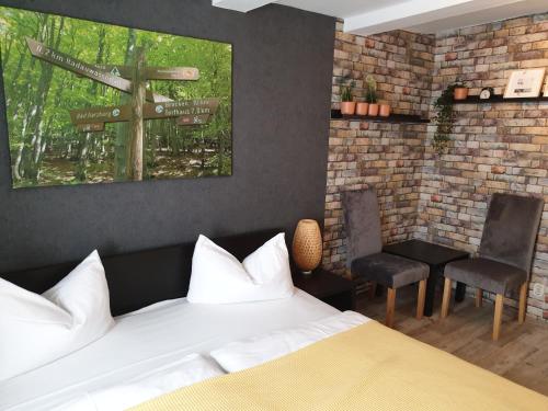 a bedroom with a bed and signs on the wall at Hotel Kammerkrug in Bad Harzburg