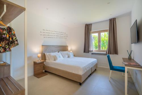 a bedroom with a bed and a desk and a window at Do' Petro Relax & Pool in Vico Equense
