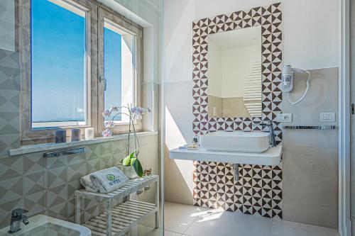 a bathroom with a sink and a mirror at Do' Petro Relax & Pool in Vico Equense