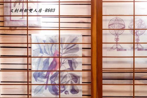 a painting of a person through a window at At Tainan Inn in Tainan