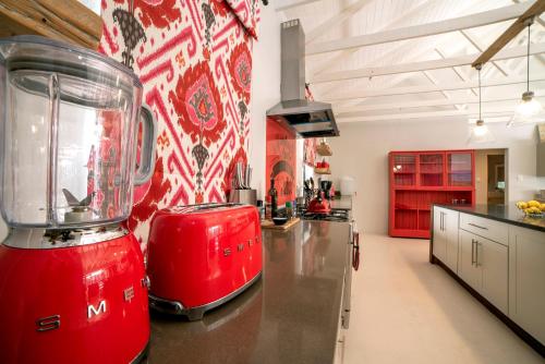 a kitchen with a red blender on a counter at Ocean Breeze by The Oyster Collection in Kenton on Sea