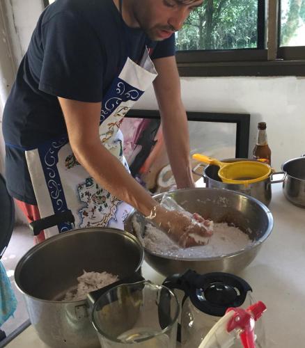 a man preparing food in a pan on a counter at Homebar in Ko Chang