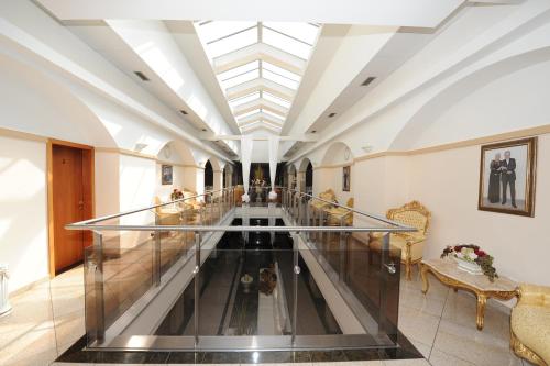 a hallway with a glass escalator in a building at Hotel MAXPLAZA in Trnava