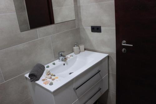 a bathroom with a white sink and a mirror at House Legacy in Bihać