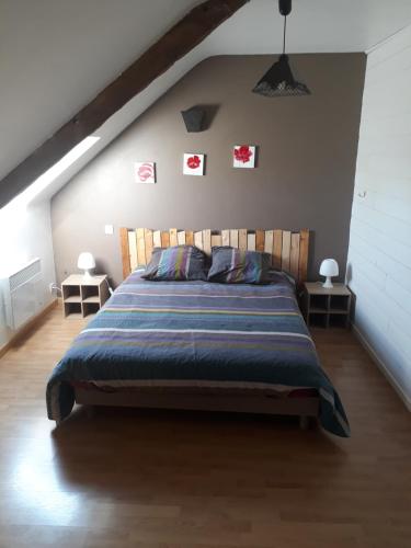 a bedroom with a large bed in a attic at La Lyonnais in Pleslin-Trigavou