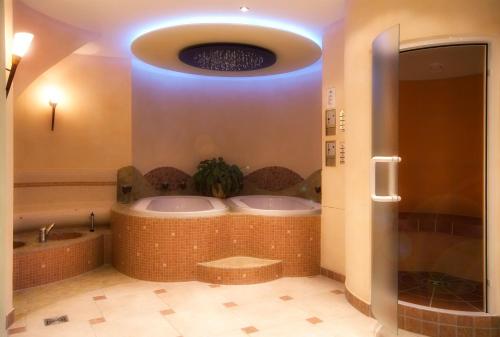 a bathroom with a jacuzzi tub in a room at Wellness-Hotel Talblick in Schömberg