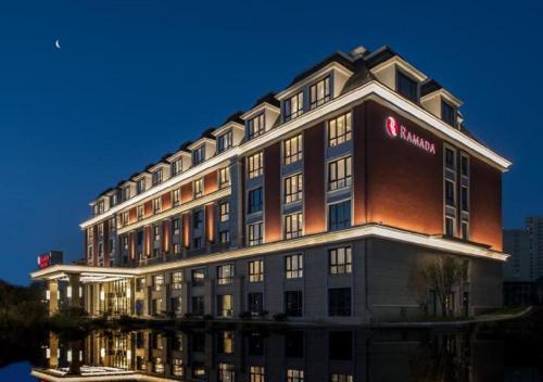 a large building with a santander sign on it at Ramada by Wyndham Zhenjiang City Center in Zhenjiang