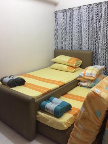 two beds sitting next to each other in a bedroom at Porte Bleue Pantai Puteri in Melaka