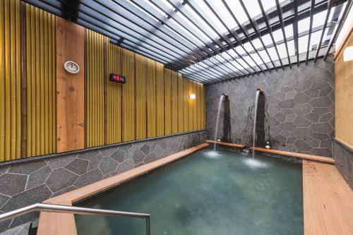 a large pool of water in a room with a ceiling at Asia Pacific Hotel Beitou in Taipei