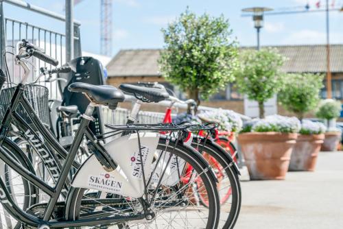 a group of bikes parked next to a fence at Skagen Harbour Hotel in Skagen