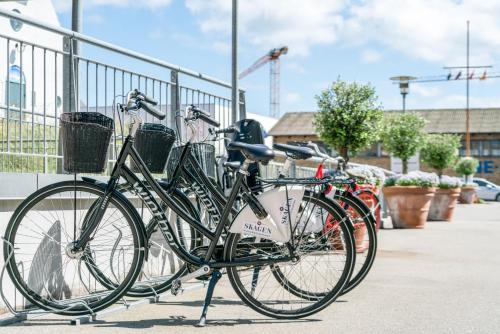 a group of bikes parked next to a fence at Skagen Harbour Hotel in Skagen