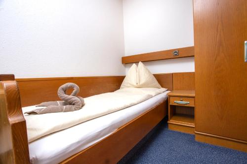 a small room with a bed with a towel on it at Berghof Mitterberg in Gröbming