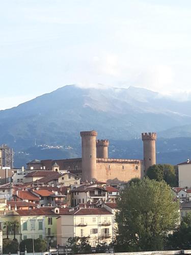a city with towers and buildings and a mountain in the background at CameLia in Ivrea