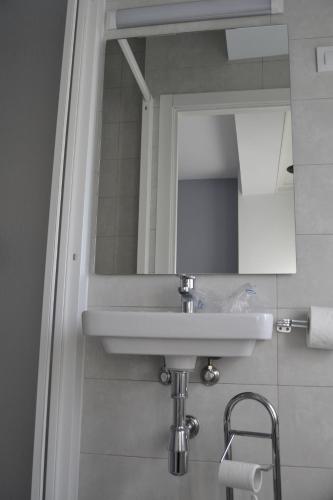 a bathroom with a sink and a mirror at Pensión Rama in Carballo