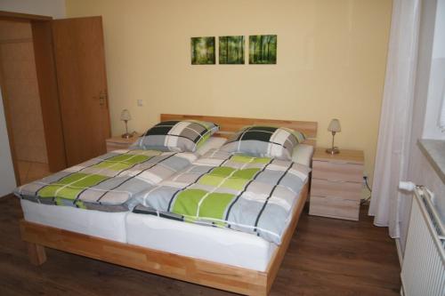 a bedroom with a large bed with two pillows at Ferienwohnung Feldberger Seenlandschaft in Neuhof