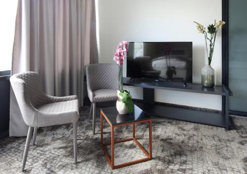 TV a/nebo společenská místnost v ubytování Hotel Koncept Residence