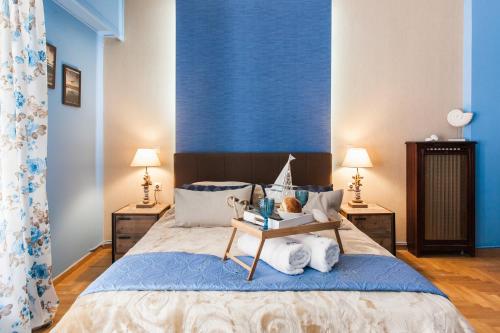 a bedroom with a large bed with blue walls at Cozy, Central, Safe Double rooms in apartment, close to Acropolis in Athens