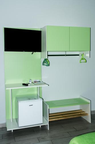 a white desk with a television on top of it at B&B Le isole in Naples