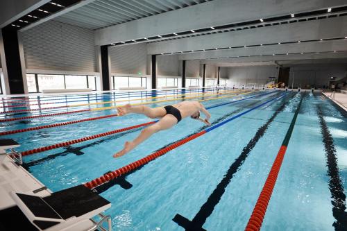 a swimming pool with several people in it at CAMPUS SURSEE Seminarzentrum in Sursee
