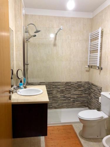 a bathroom with a sink and a toilet and a shower at InPorto in Porto