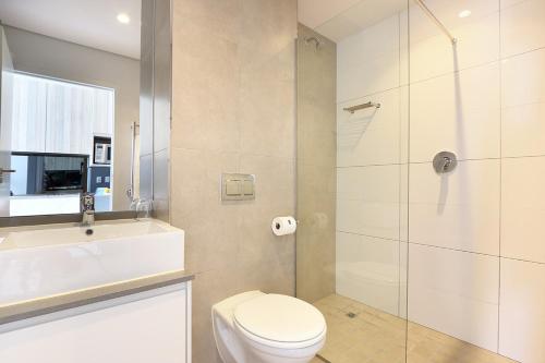 a bathroom with a toilet and a glass shower at Trendy, Central Sentinel - Heart of Cape Town in Cape Town
