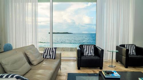 a living room with a view of the ocean at Cap el Limon Luxury Villas in El Limón