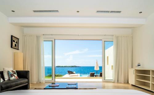 a living room with a view of the ocean at Cap el Limon Luxury Villas in El Limón