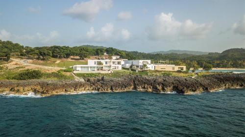 an aerial view of a house on an island in the ocean at Cap el Limon Luxury Villas in El Limón