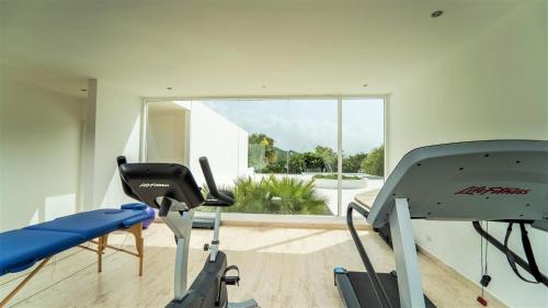 a room with a gym with a treadmill at Cap el Limon Luxury Villas in El Limón
