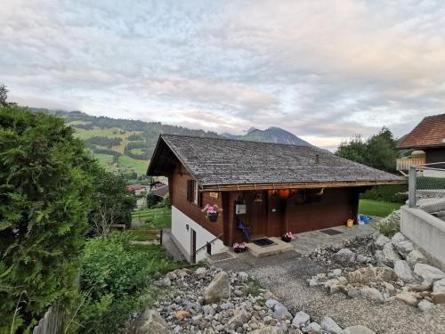 a small house with a mountain in the background at Chalet Solaria 2 bedrooms with mountain and garden view in Zweisimmen