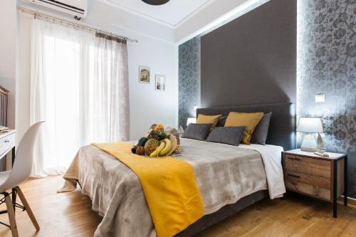 a bedroom with a large bed with a yellow blanket at Cozy, Central, Safe Double rooms in apartment, close to Acropolis in Athens