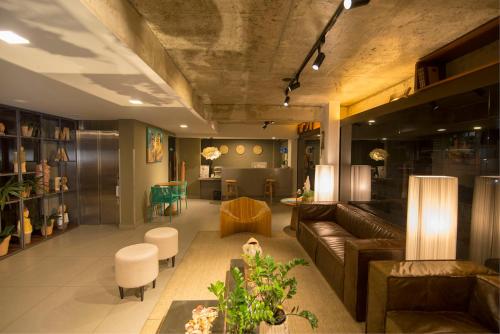 a living room with a couch and a table at Hotel do Mar Cabo Branco in João Pessoa