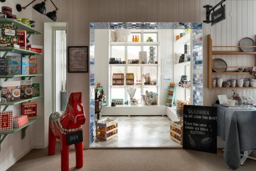 a shop with a table and a chair in a room at Skytteholm in Ekerö