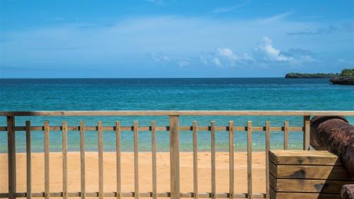 a view of the ocean from a fence on the beach at Cap el Limon Luxury Villas in El Limón