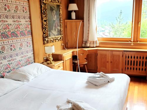 En eller flere senger på et rom på Supermountainski Cortina