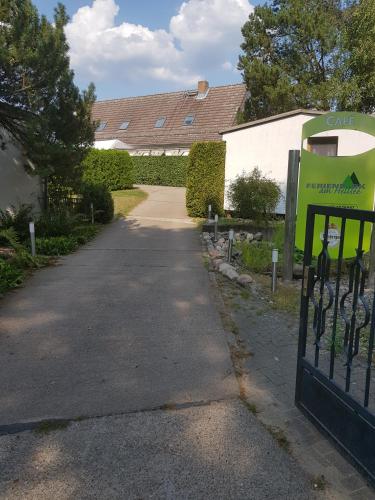 a driveway with a gate in front of a house at Ferienpark am Hellsee in Biesenthal
