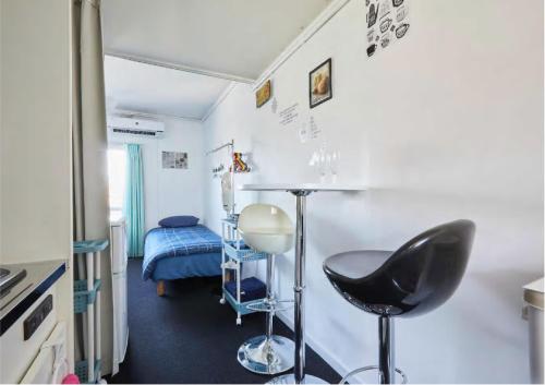 a room with a chair and a table and a bed at 2BR 5beds Shibuya Shinjuku Harajuku 10min wifi in Tokyo