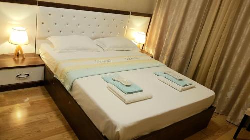 a bedroom with a bed with towels on it at Tbilisi Sea Dream Apartment in Tbilisi City