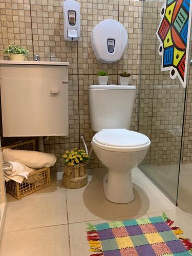 a bathroom with a white toilet in a room at Mandala House Container in Chapada dos Guimarães